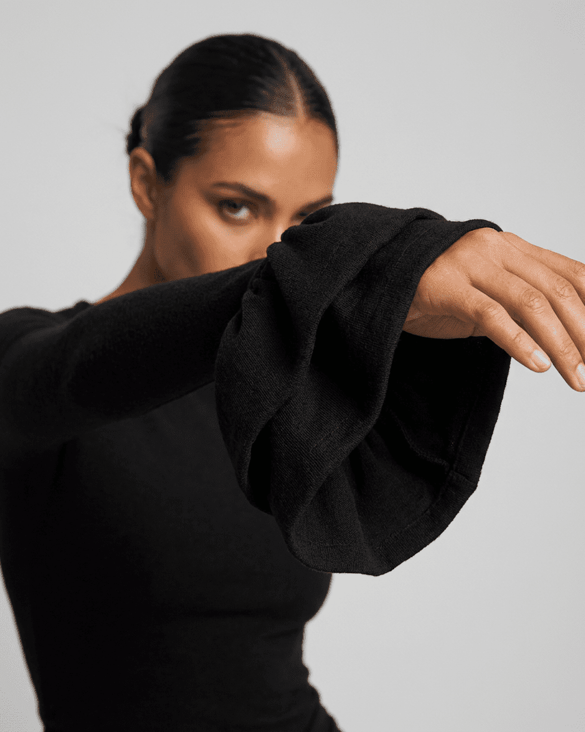 Orion Mini Dress by Lauven showcasing elegant ruffled sleeves and a sleek black design.