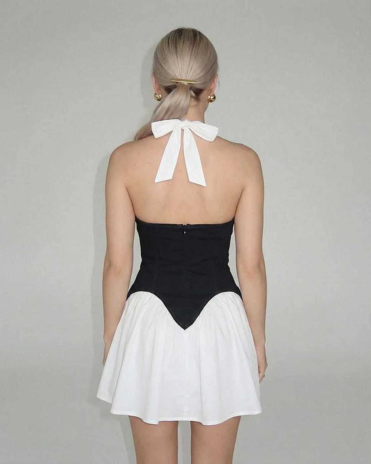 Orion Mini Dress by Lauven featuring a chic color block design with a white skirt and black corset panel.