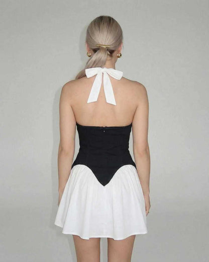 Orion Mini Dress by Lauven featuring a chic color block design with a white skirt and black corset panel.