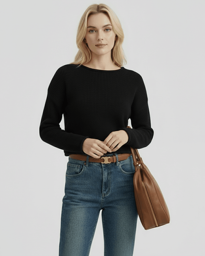 Orion Sweater by Lauven, women's black sweater with ribbed knit texture, paired with denim jeans and a brown handbag.