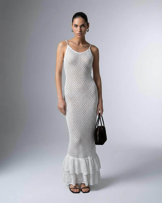 Pearl Maxi Dress by Lauven worn by a model, featuring a hollow-out knit texture and flared hem design.