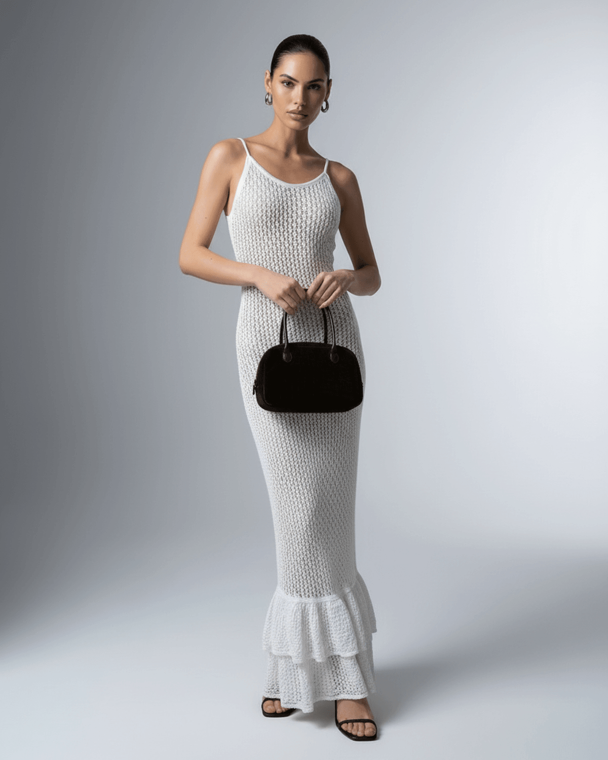 Model wearing Lauven Pearl Maxi Dress, a white hollow out bodycon maxi dress, showcasing its elegant design.