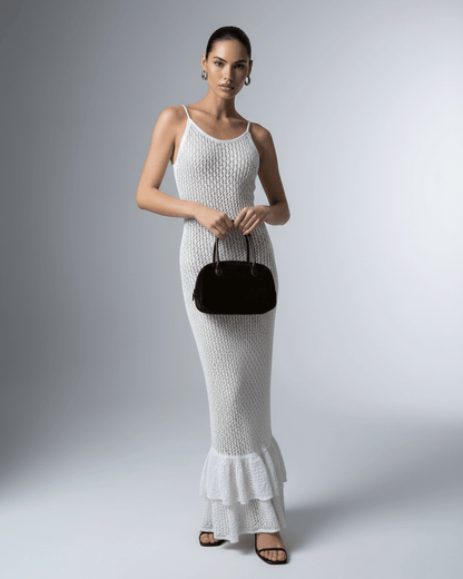 Model wearing Lauven Pearl Maxi Dress, a white hollow out bodycon maxi dress, showcasing its elegant design.