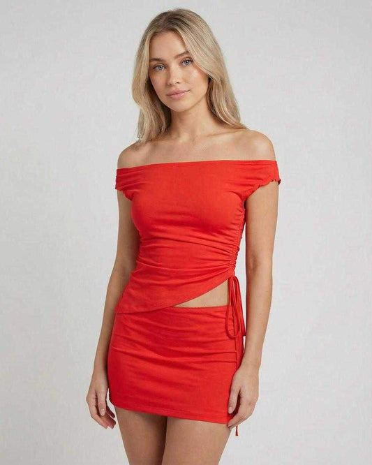 Riviera Mini Dress by Lauven featuring an asymmetric off-shoulder design and a high waist mini skirt in red.