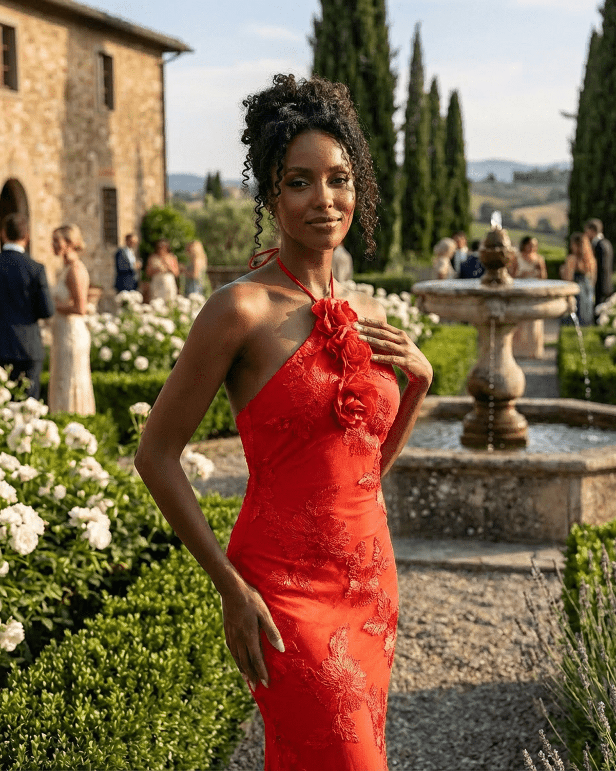 Rosalia Maxi Dress by Lauven, displaying a model in a bold red halter neck dress with 3D floral details in a scenic garden.