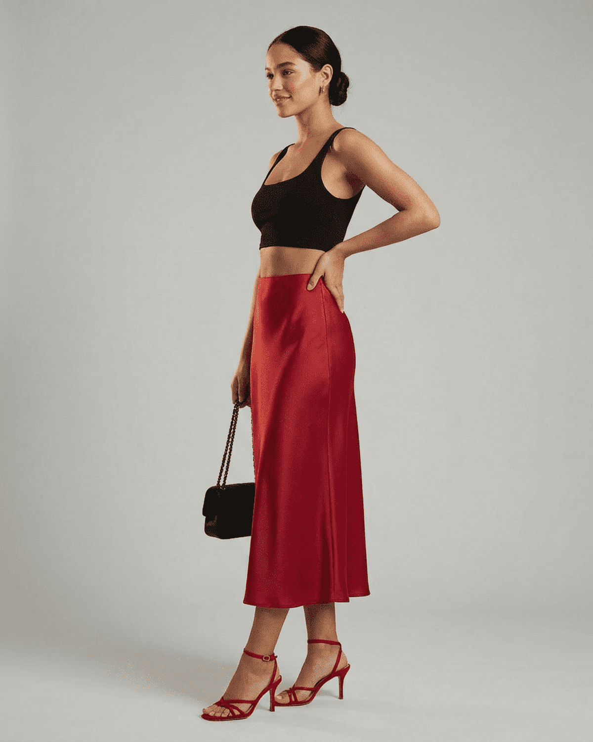 Model showcasing Rosalia Midi Skirt by Lauven, a refined satin mermaid midi skirt in rich red hue.