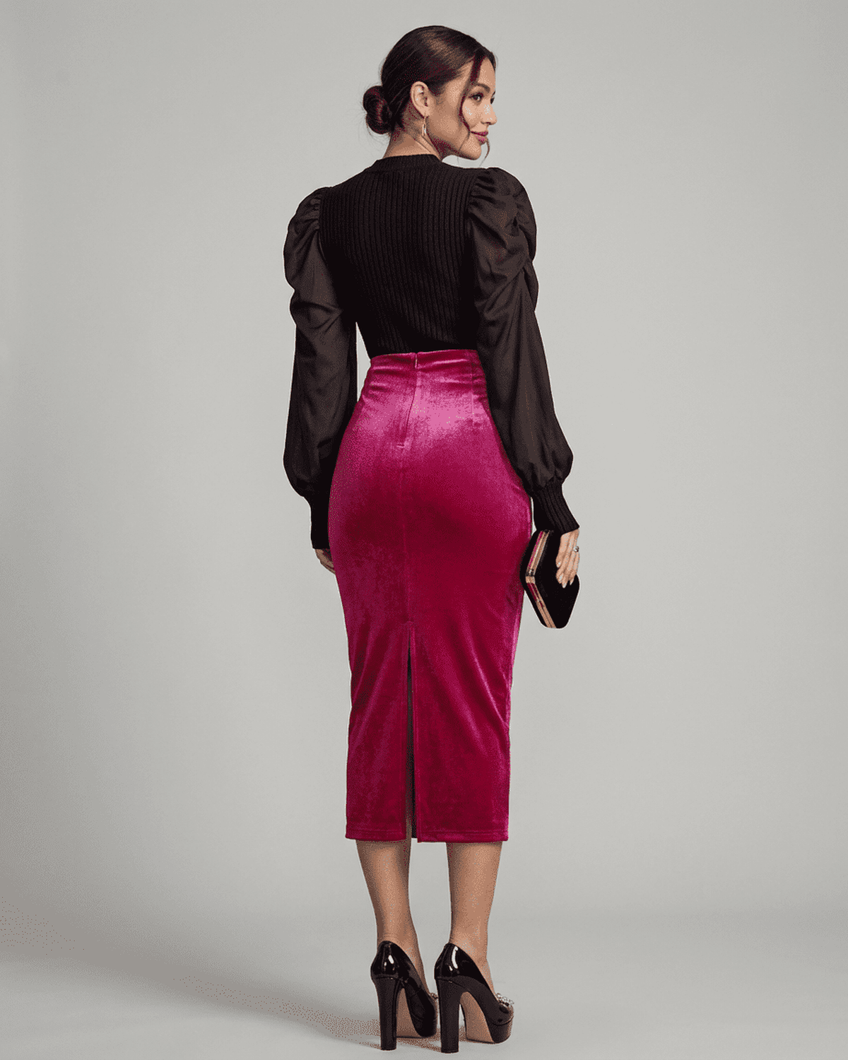Elegant woman in Rosalia Midi Skirt by Lauven, showcasing velvet texture and back slit details.