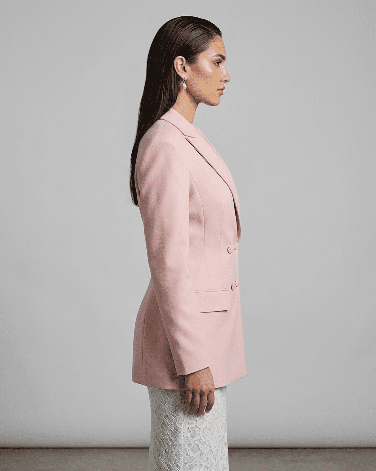 Side view of model wearing the elegant Rosalie Blazer by Lauven, showcasing its tailored silhouette in pink.