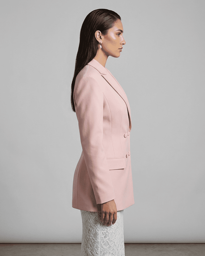 Side view of model wearing the elegant Rosalie Blazer by Lauven, showcasing its tailored silhouette in pink.