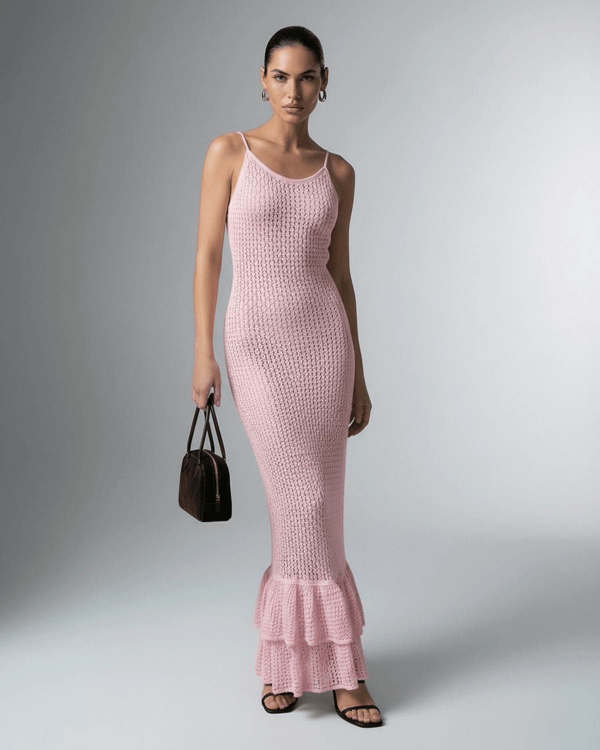 Rosaline Maxi Dress by Lauven featuring a pink bodycon silhouette with hollow out knit texture and ruffled hem.