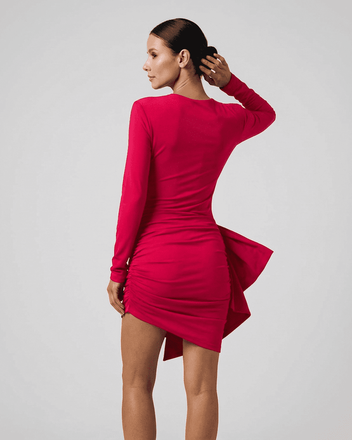 Ruby Mini Dress by Lauven showcasing a sleek fitted silhouette with ruched detailing in vibrant pink.