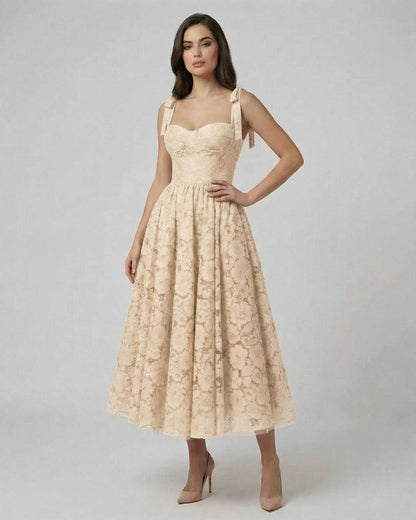 Model wearing the Sable Midi Dress by Lauven, a soft beige lace A-line dress with elegant design.