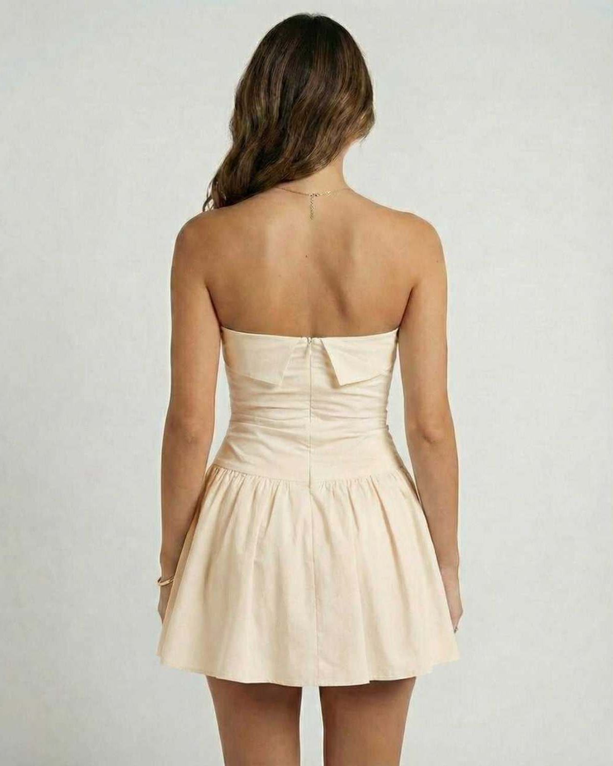 Sable Mini Dress by Lauven, elegant beige strapless A-line silhouette with flared skirt, back view.