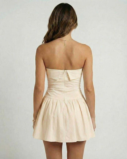 Sable Mini Dress by Lauven, elegant beige strapless A-line silhouette with flared skirt, back view.