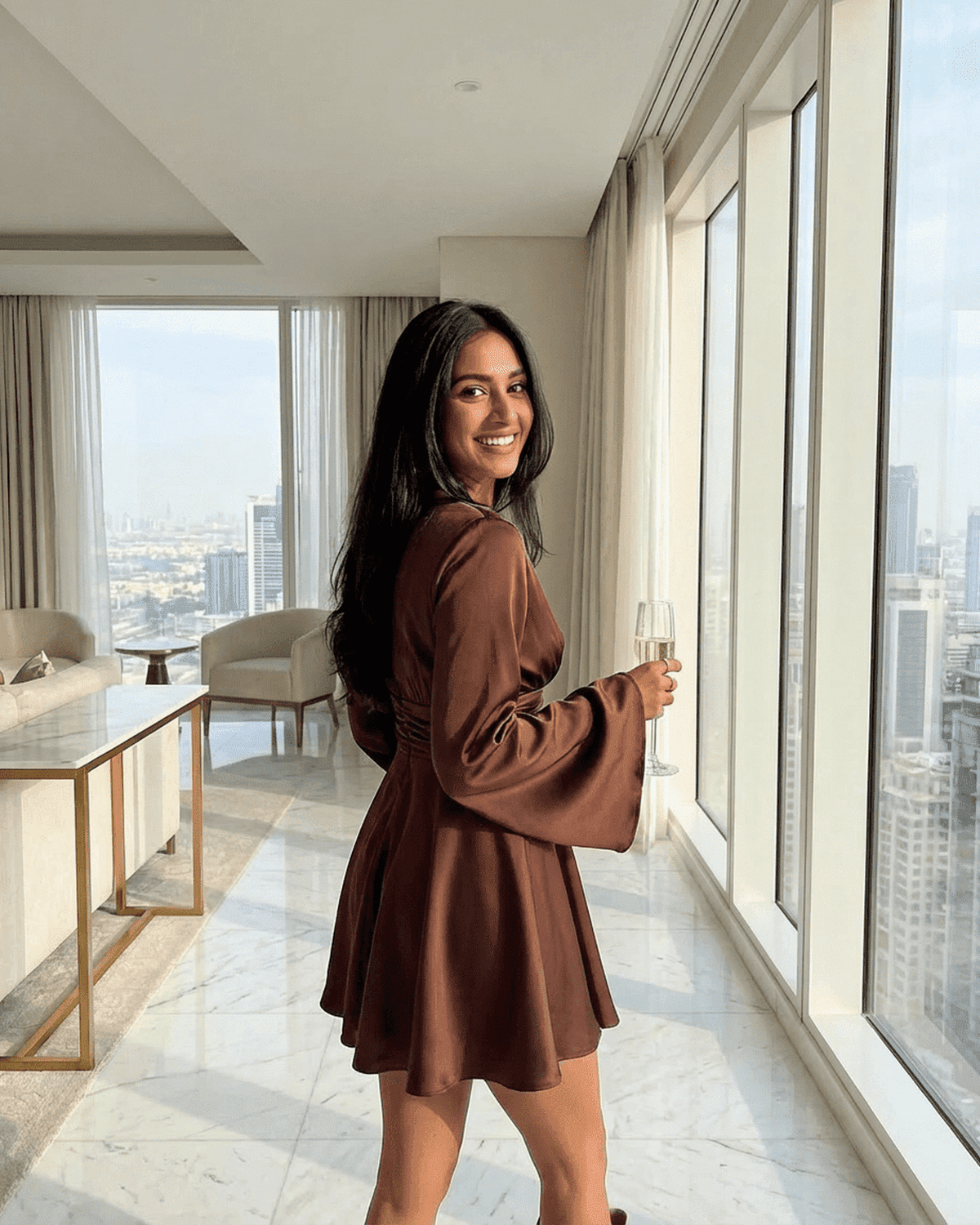 Woman in Sable Mini Dress by Lauven, showcasing elegant design and stylish silhouette in a modern interior.