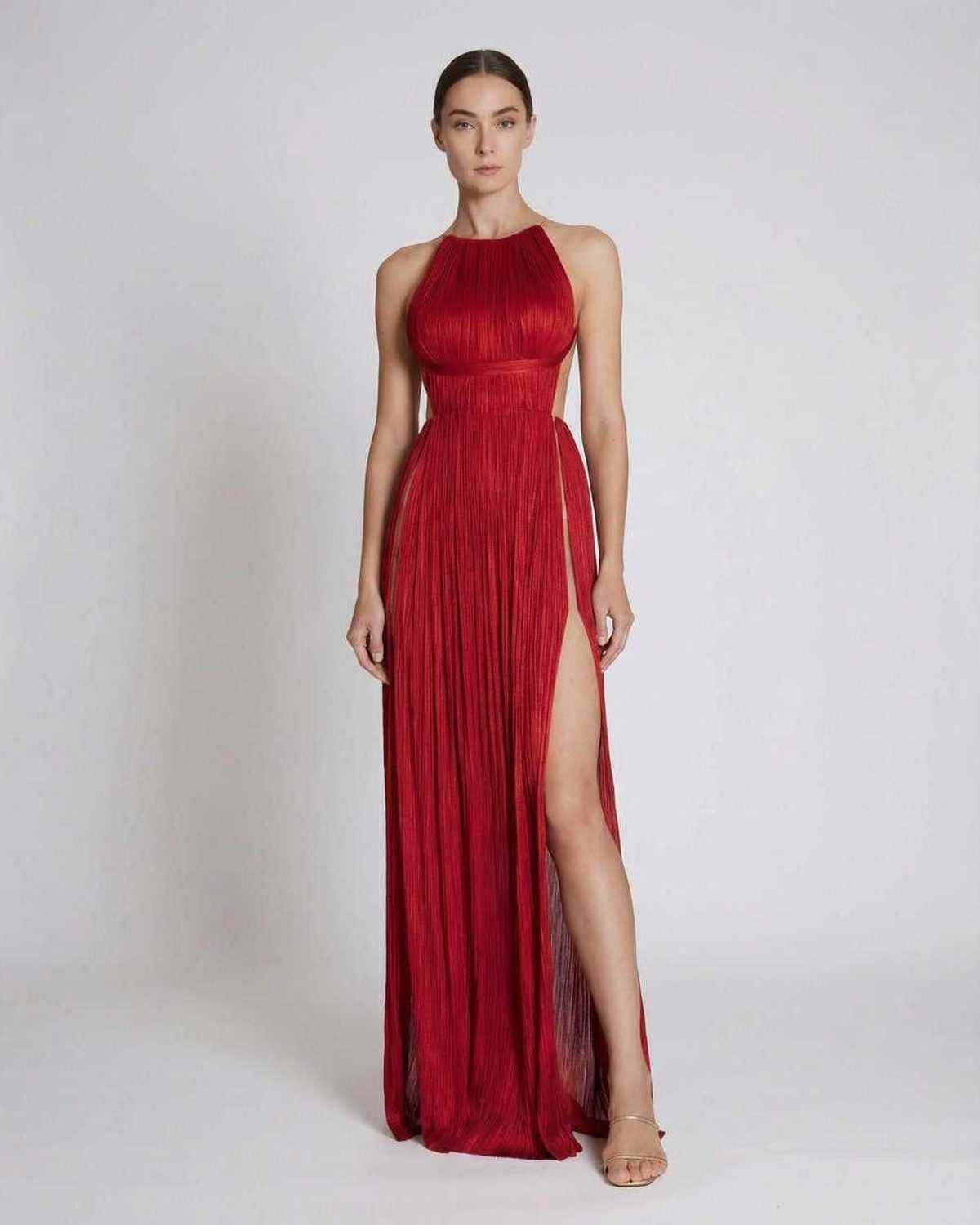 Saffron Maxi Dress by Lauven, pleated red sheath gown with halter neckline and high slit showcased on model.