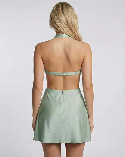 Back view of Lauven Sage Mini Dress in soft satin, featuring halter neck and cut-out detailing, ideal for summer style.