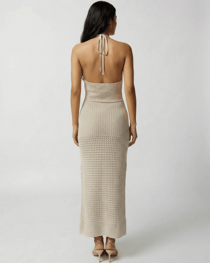 Back view of a woman in the Sahara Maxi Dress by Lauven, showcasing crochet halter neck and ankle-length design.