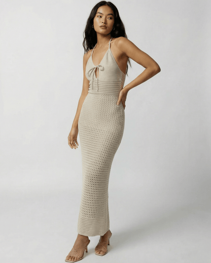 Sahara Maxi Dress by Lauven featuring a crochet halter neck design and ankle-length silhouette in soft neutral tone.