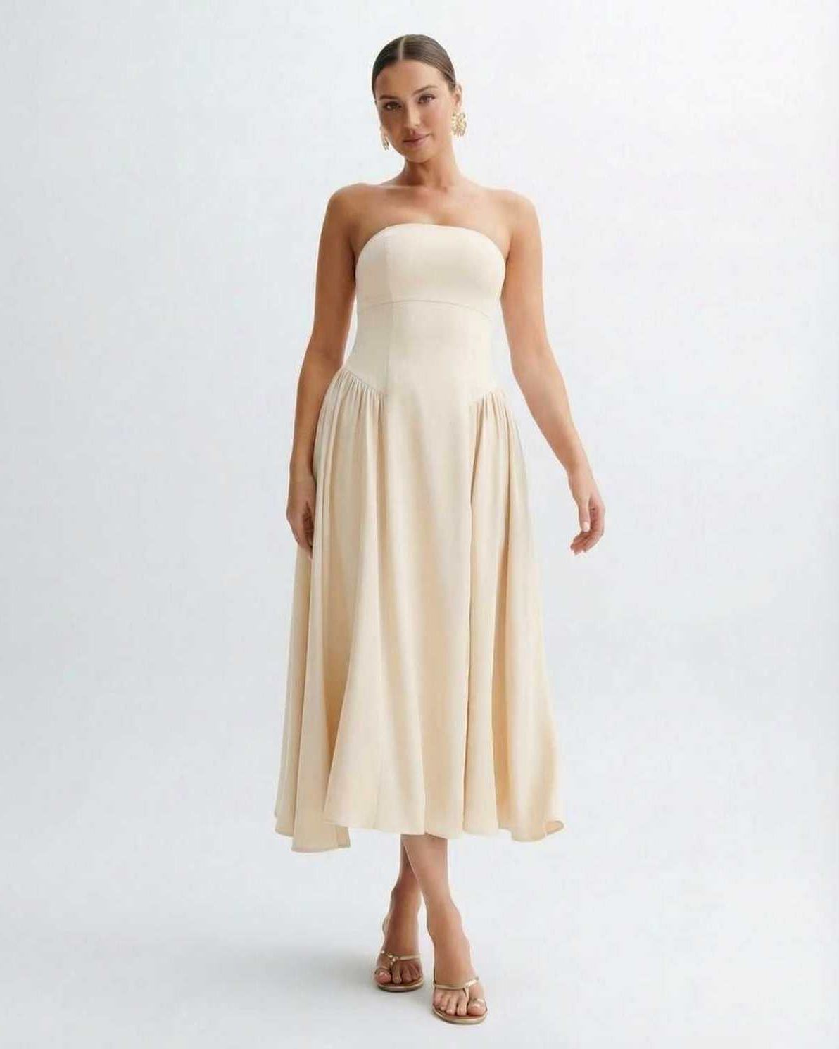 Sahara Midi Dress - Strapless beige pleated dress by Lauven, showcasing elegant style and graceful movement.