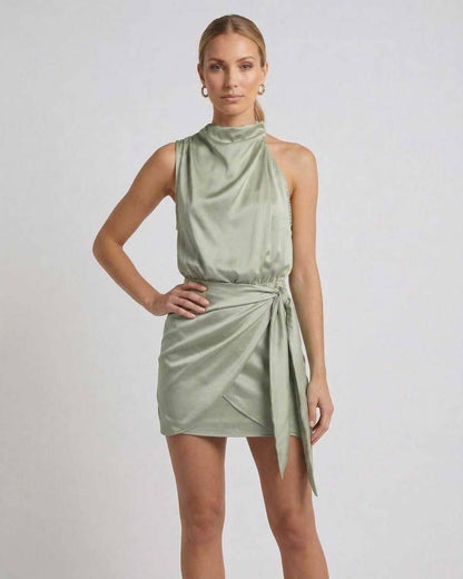 Sahara Mini Dress by Lauven in soft sage green with draped high neck and wrap tie detail.