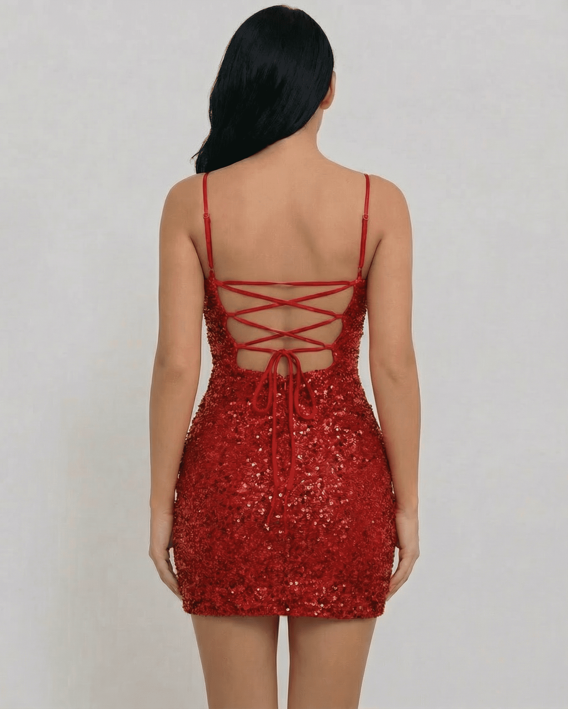 Back view of the Scarlet Mini Dress by Lauven, showcasing the red sequin fabric and lace-up detail.