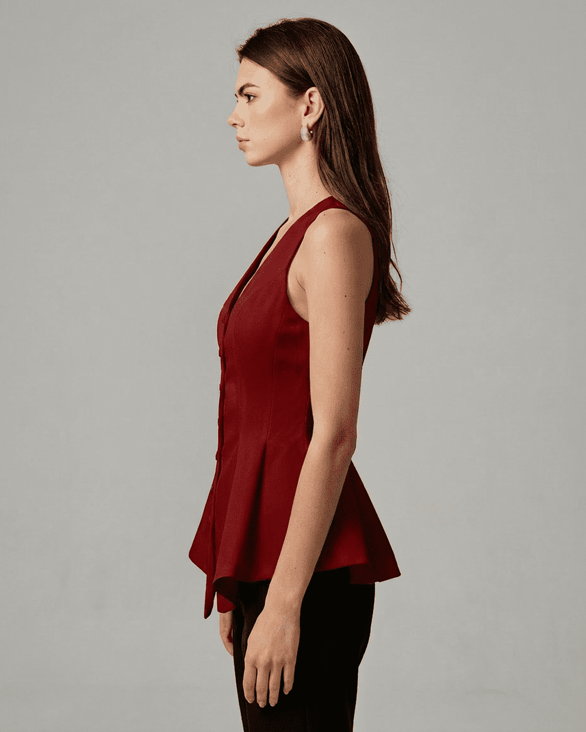 Scarlett Blouse by Lauven, elegant satin sleeveless top in rich red with tailored peplum silhouette.