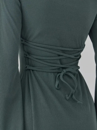 Back detail of the Sculpt Flare dark olive mini dress by Lauven, featuring lace-up ties for a flattering silhouette.