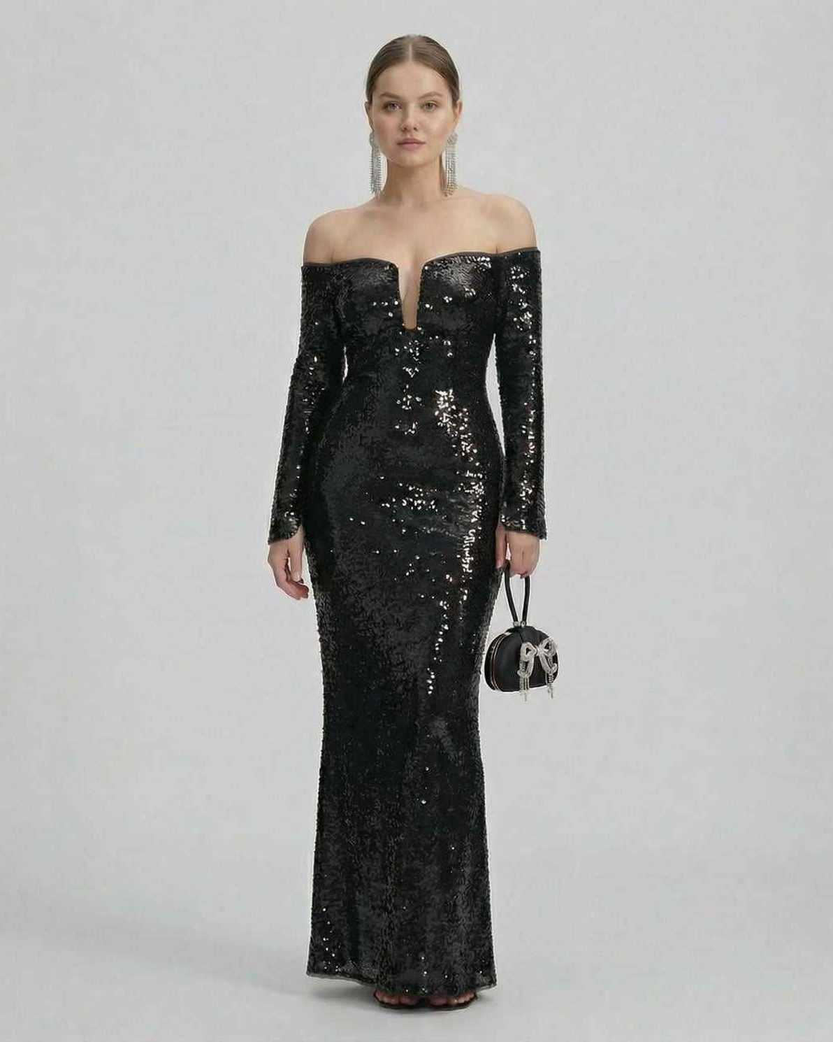 Selene Maxi Dress by Lauven, a black sequined off-shoulder evening gown with a dramatic plunge neckline.