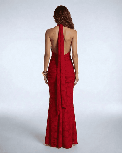 Back view of the Seraphina Maxi Dress by Lauven, showcasing its deep V-neck and dramatic ribbon tie detail.