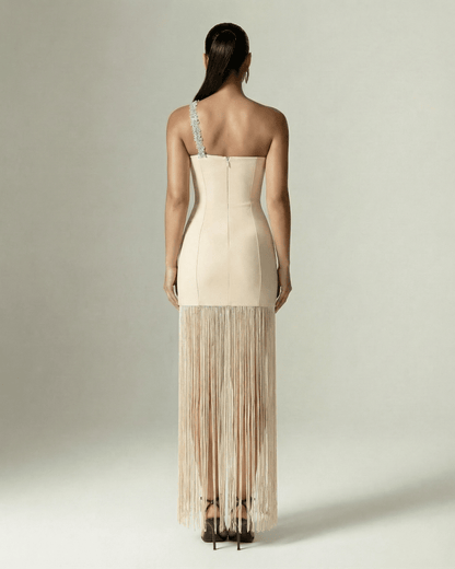 Seraphine Maxi Dress by Lauven, nude one-shoulder sheath with fringe hem, elegant back view showcasing crystal embellishment.