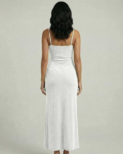 Back view of a woman wearing the Serena Midi Dress by Lauven, featuring a white slim fit design with spaghetti straps.