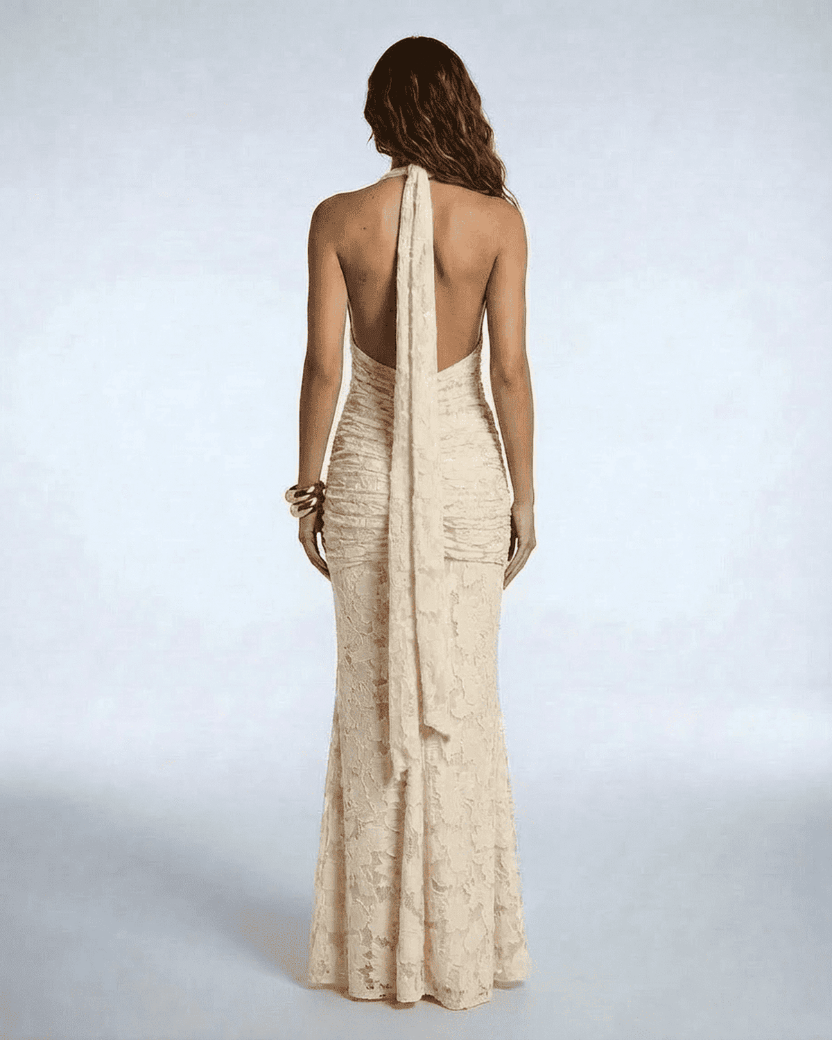 Back view of Serenella Maxi Dress by Lauven showcasing elegant ruched design and stunning tie ribbon.
