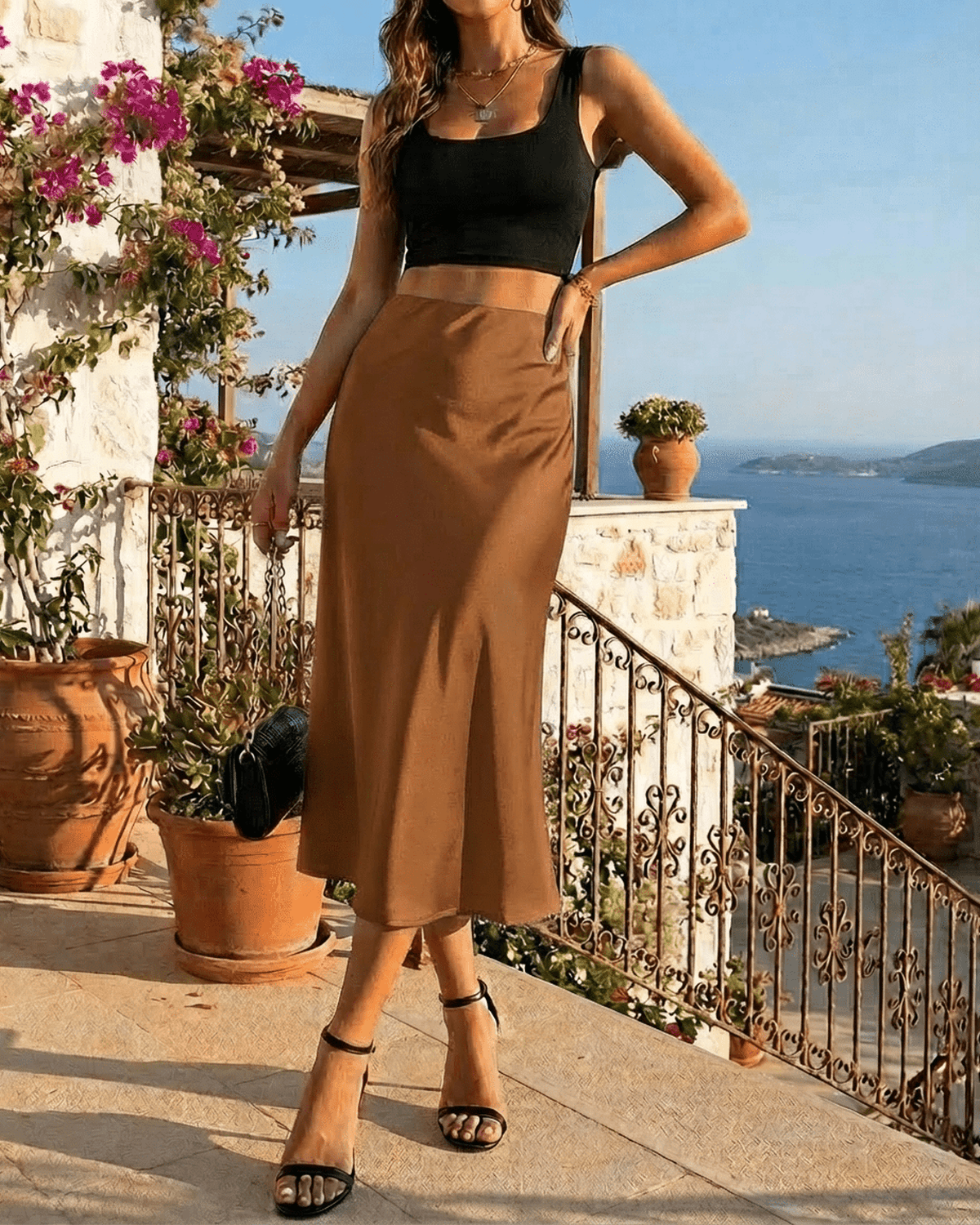 Siena Midi Skirt by Lauven, showcasing fluid satin drape and high-waisted silhouette against a scenic backdrop.