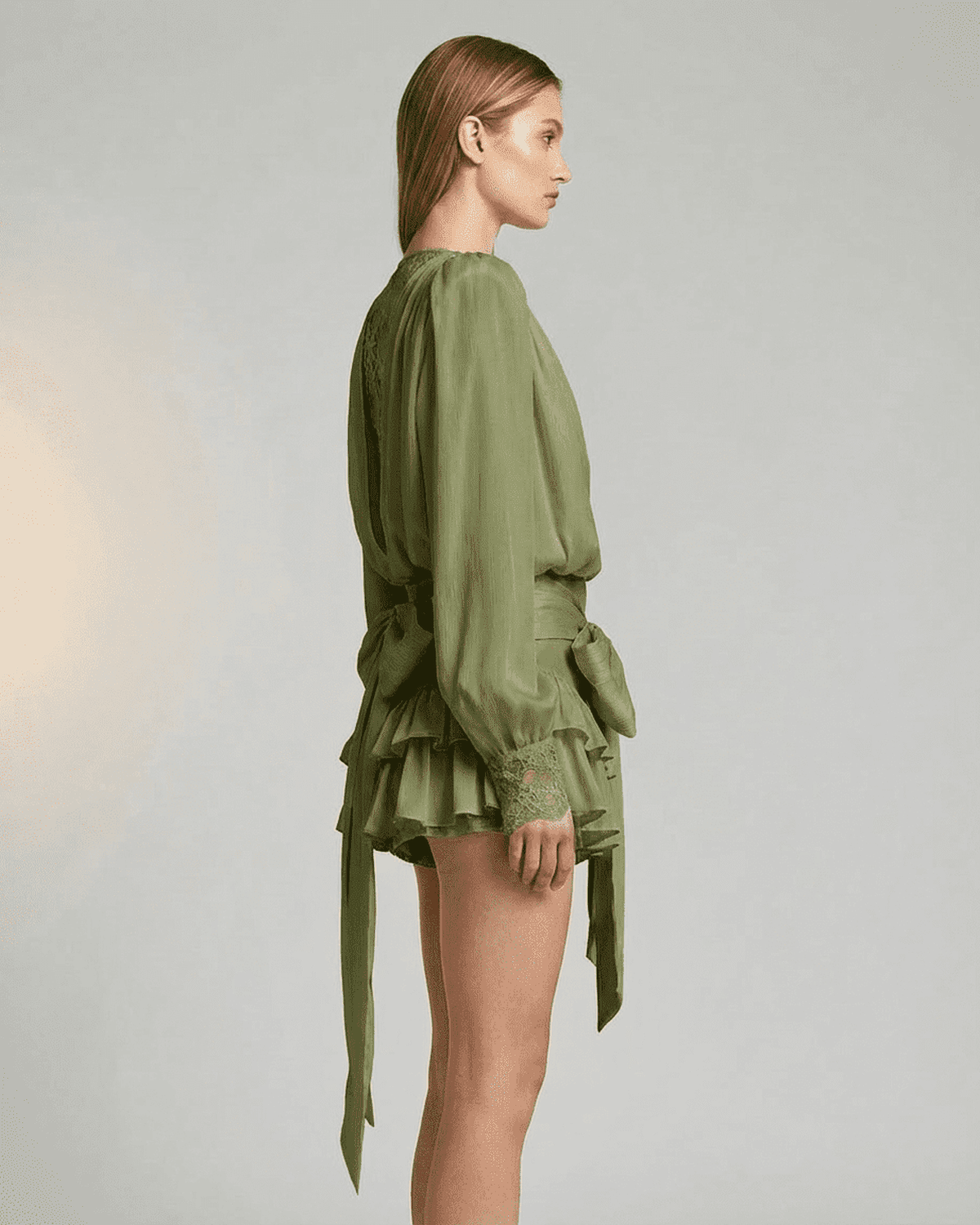 Side view of the Siena Mini Dress by Lauven featuring a tiered silhouette and long sleeves.