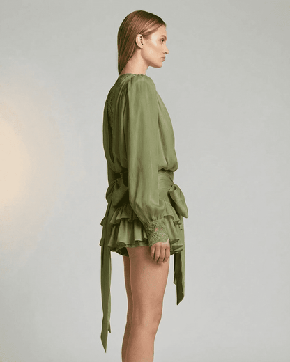 Side view of the Siena Mini Dress by Lauven featuring a tiered silhouette and long sleeves.