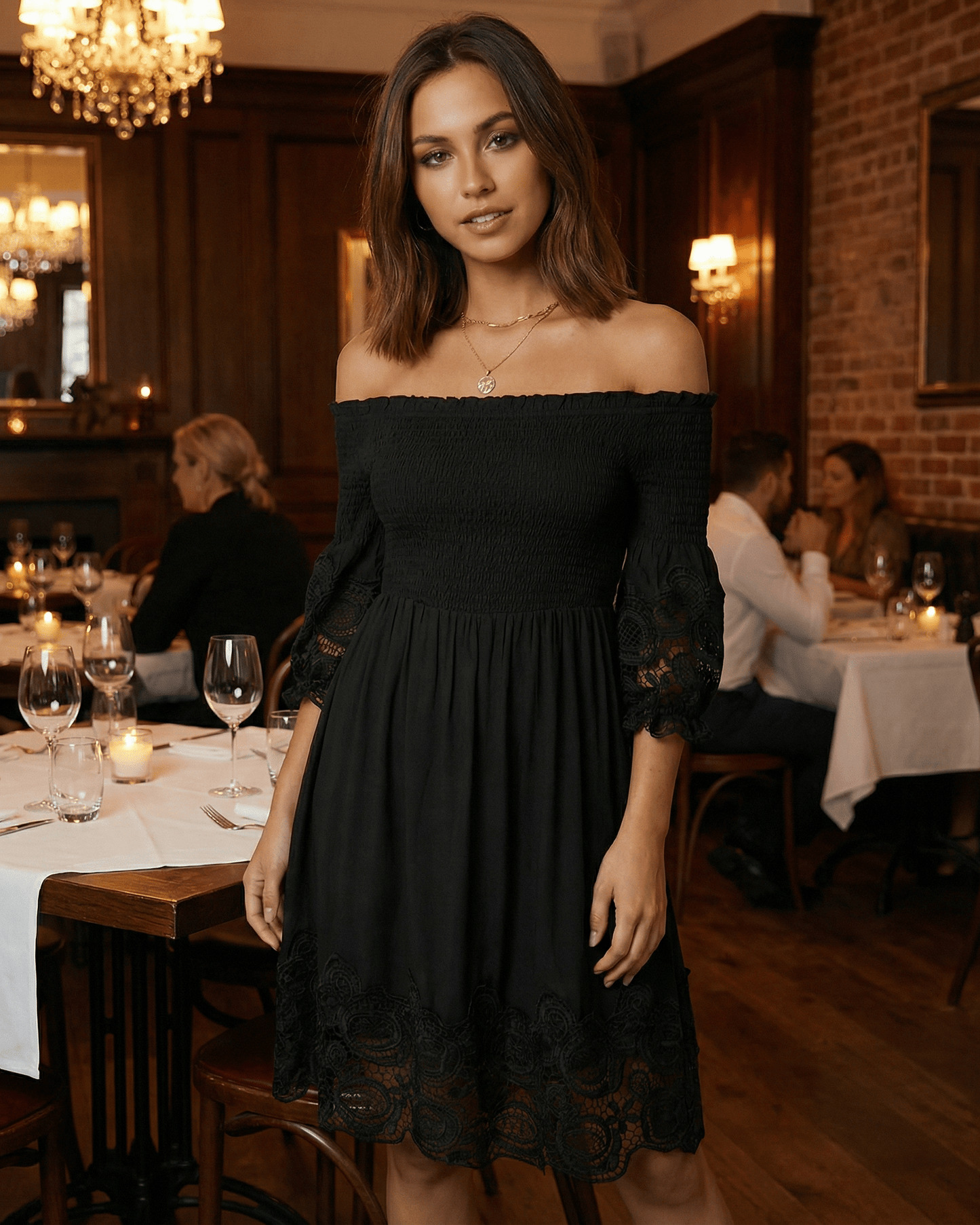 Sienna Midi Dress by Lauven - Elegant black off shoulder lace A-Line silhouette in a stylish restaurant setting.