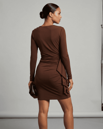 Back view of a model wearing the Sienna Mini Dress by Lauven, showcasing its ruched bodycon design.