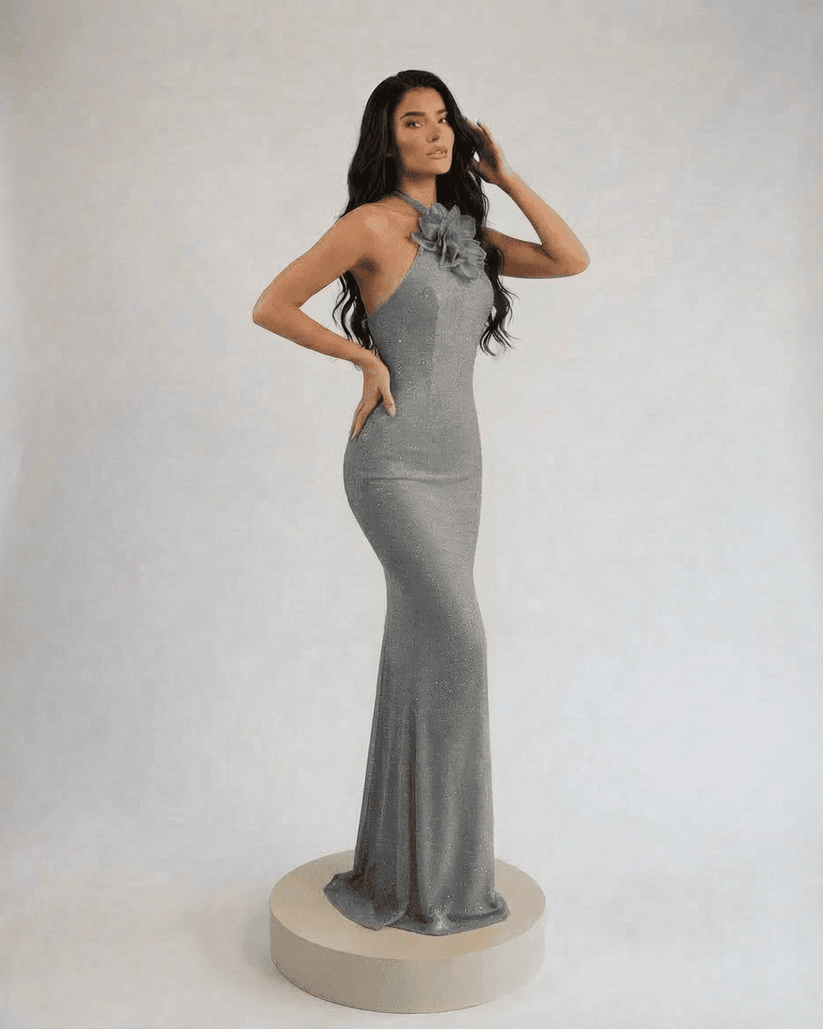 Lauven Silver Maxi Dress with halter neck and floral accent, showcasing elegance in silver-gray shimmer.