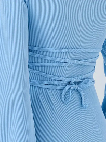 Sky Belle by Lauven, showcasing the back detail of a pastel blue ribbed knit mini dress.