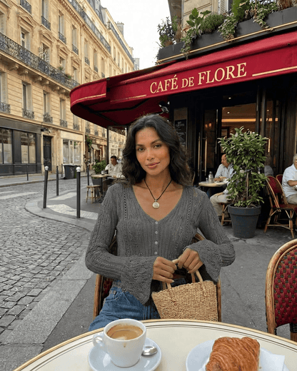 Slate Cardigan by Lauven worn at Café de Flore, showcasing a stylish cropped cotton knit with flare sleeves.