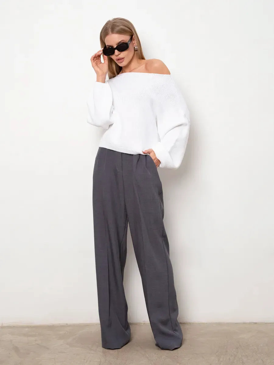 Model in oversized Snowfall Sweater by Lauven paired with grey pants, showcasing stylish modern fashion.