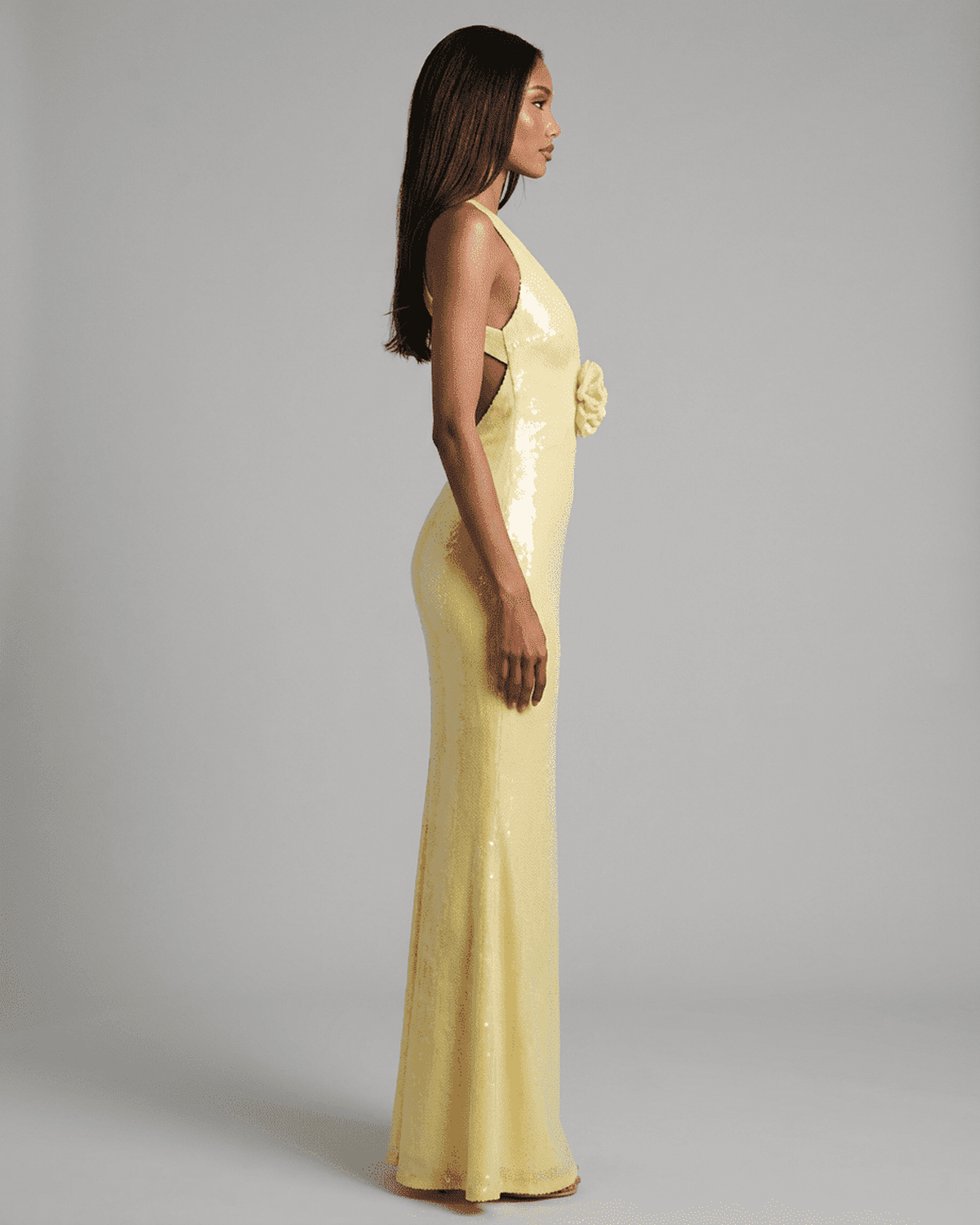 Solara Maxi Dress by Lauven in yellow with backless V-neck silhouette and floral sequin detail.