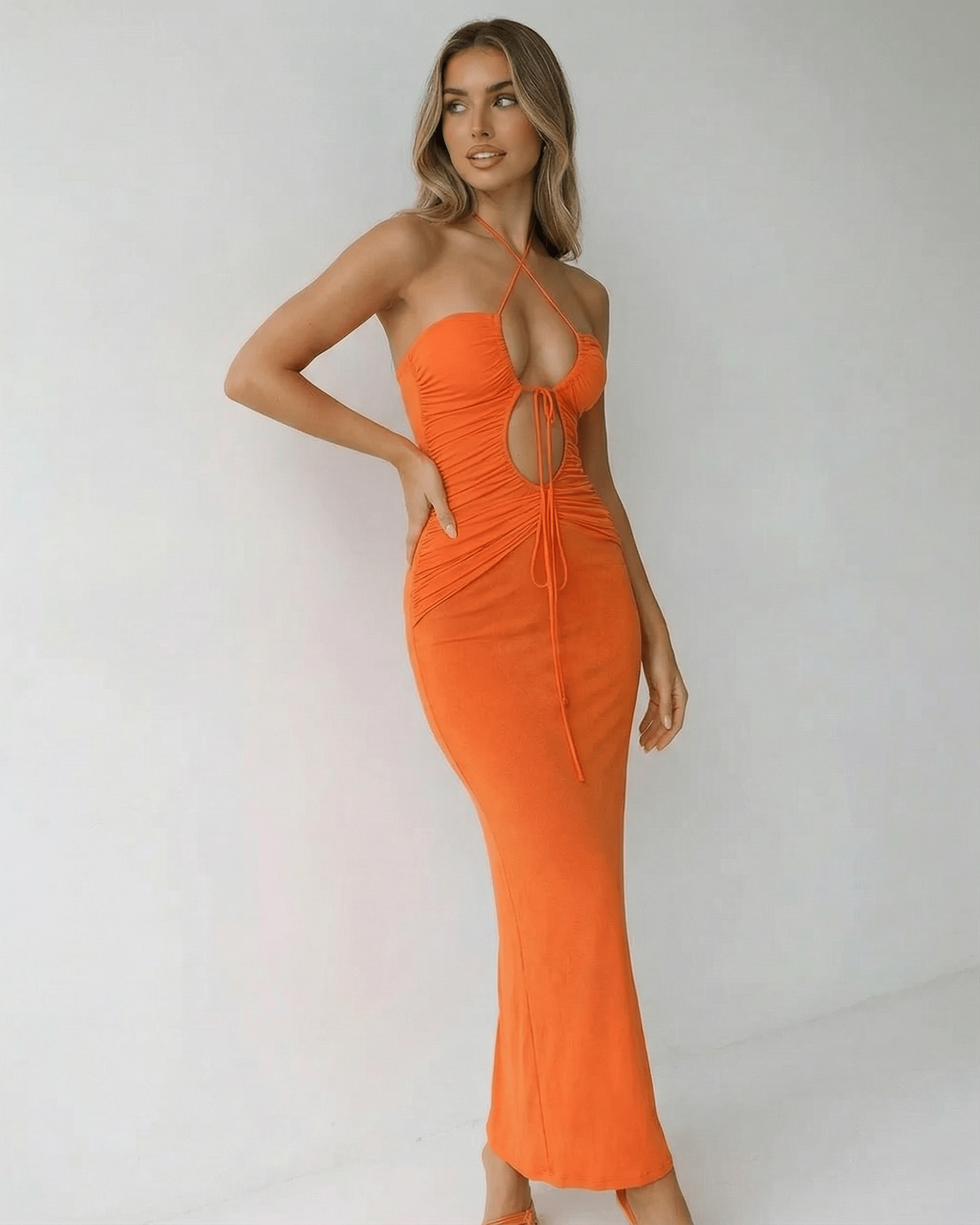 Solara Maxi Dress by Lauven featuring a halter neck and ruched detail in vibrant orange.