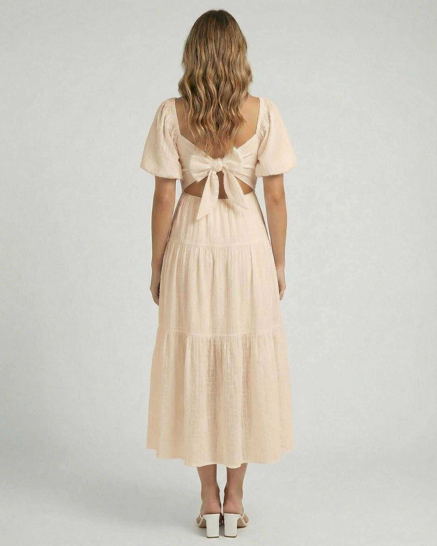 Solene Midi Dress by Lauven – Soft beige A-line dress featuring a back bow detail and elegant silhouette.