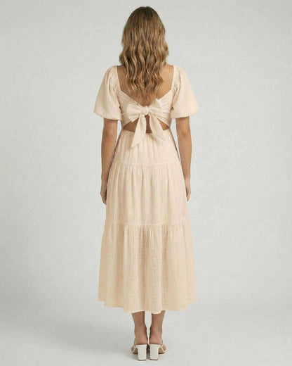 Solene Midi Dress by Lauven – Soft beige A-line dress featuring a back bow detail and elegant silhouette.