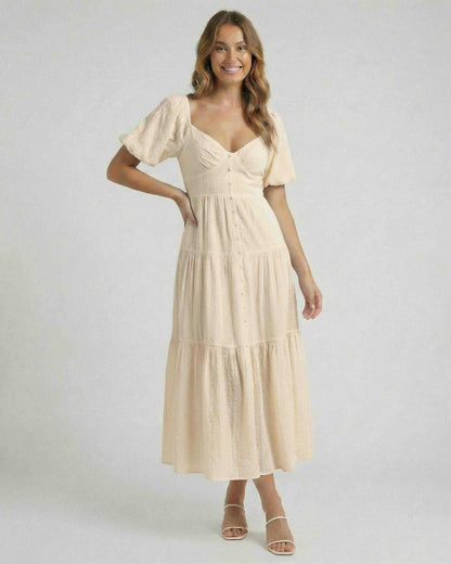Solene Midi Dress by Lauven – Soft beige A-Line midi dress with back bow detail and V-neckline.