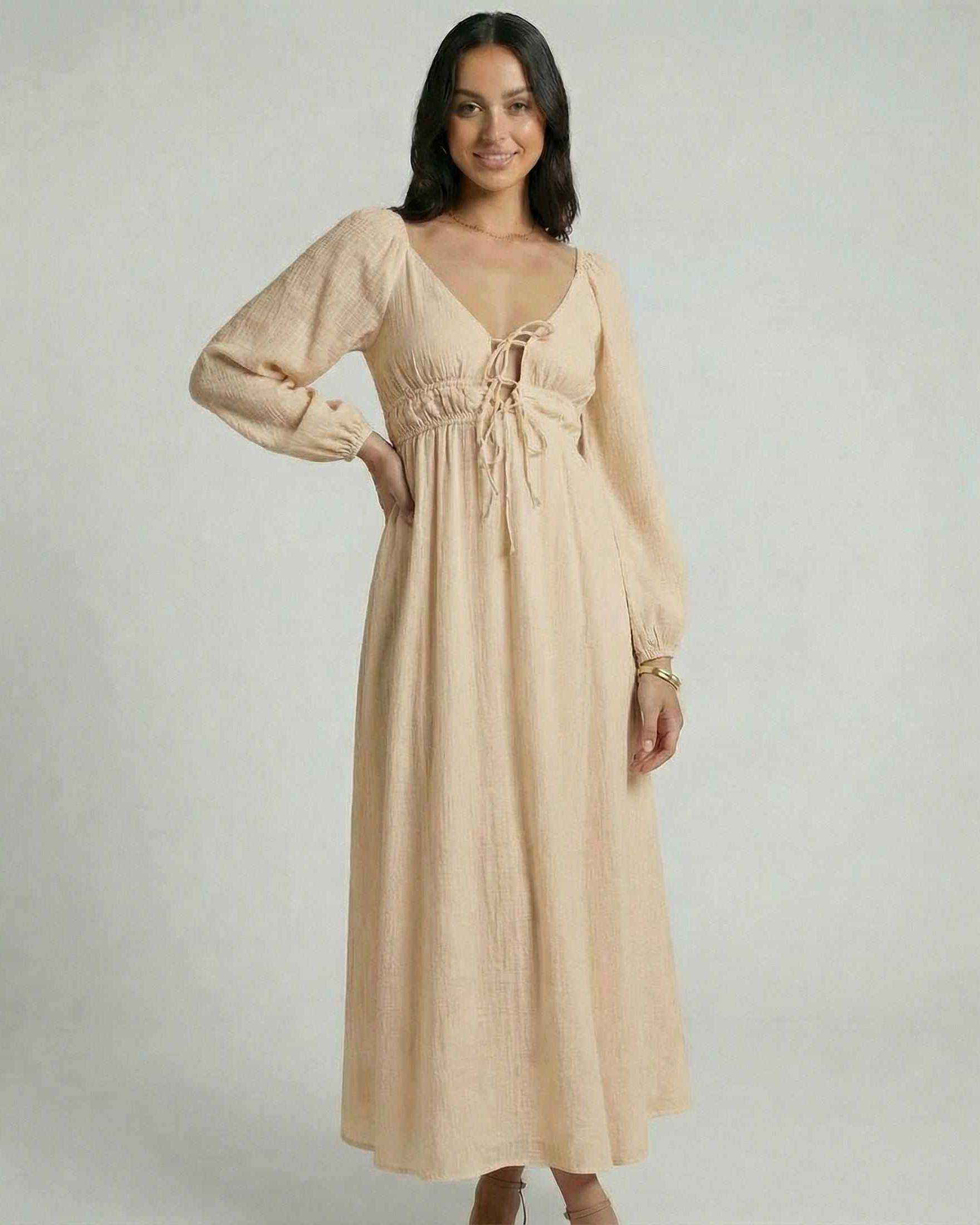 Solenne Maxi Dress by Lauven in beige, featuring a V-neck, empire waist, and ankle-length silhouette.