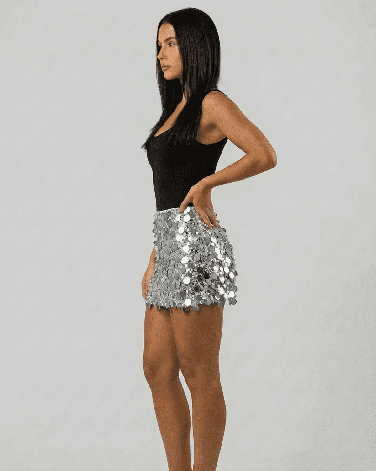 Model wearing Sterling Mini Skirt by Lauven, showcasing silver sequin hem in a stylish bodycon fit.