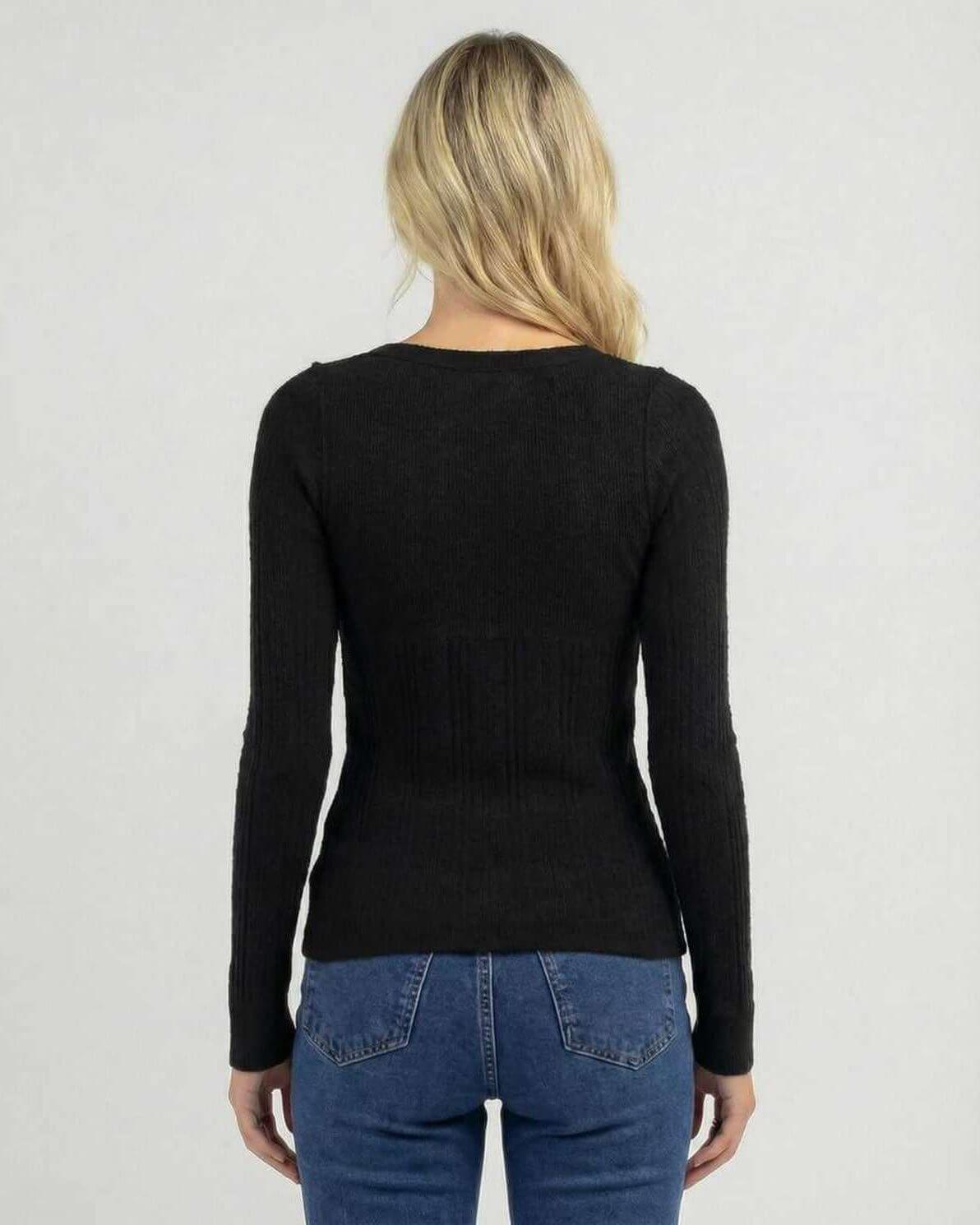 Back view of a woman wearing a Valencia Long Sleeve black ribbed knit shirt by Lauven.
